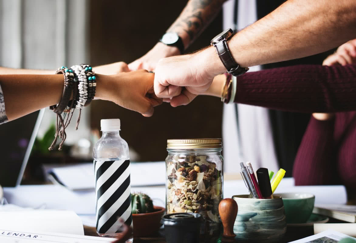 collaboration-colleagues-cooperation-398532 Fist pump